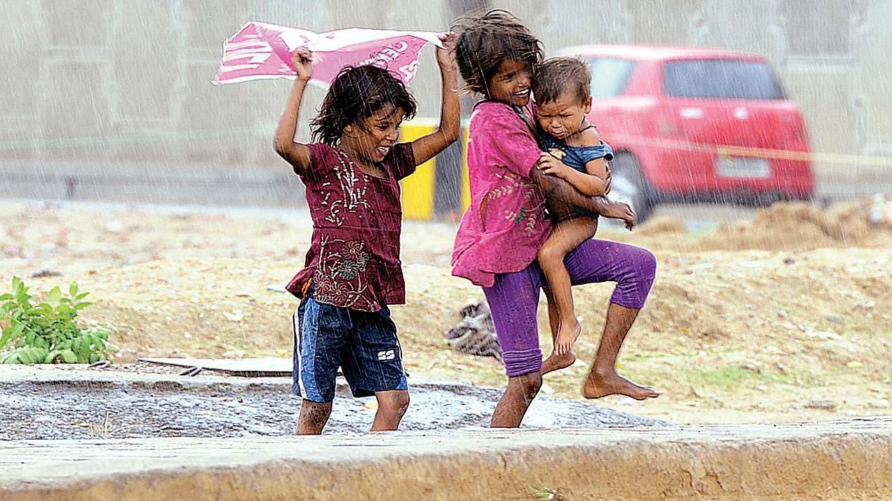 Children sheltering each other from the rain